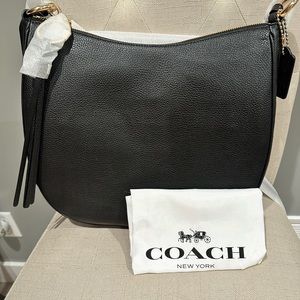 NWT authentic black leather Coach bag w/silk storage bag . Retails for $325